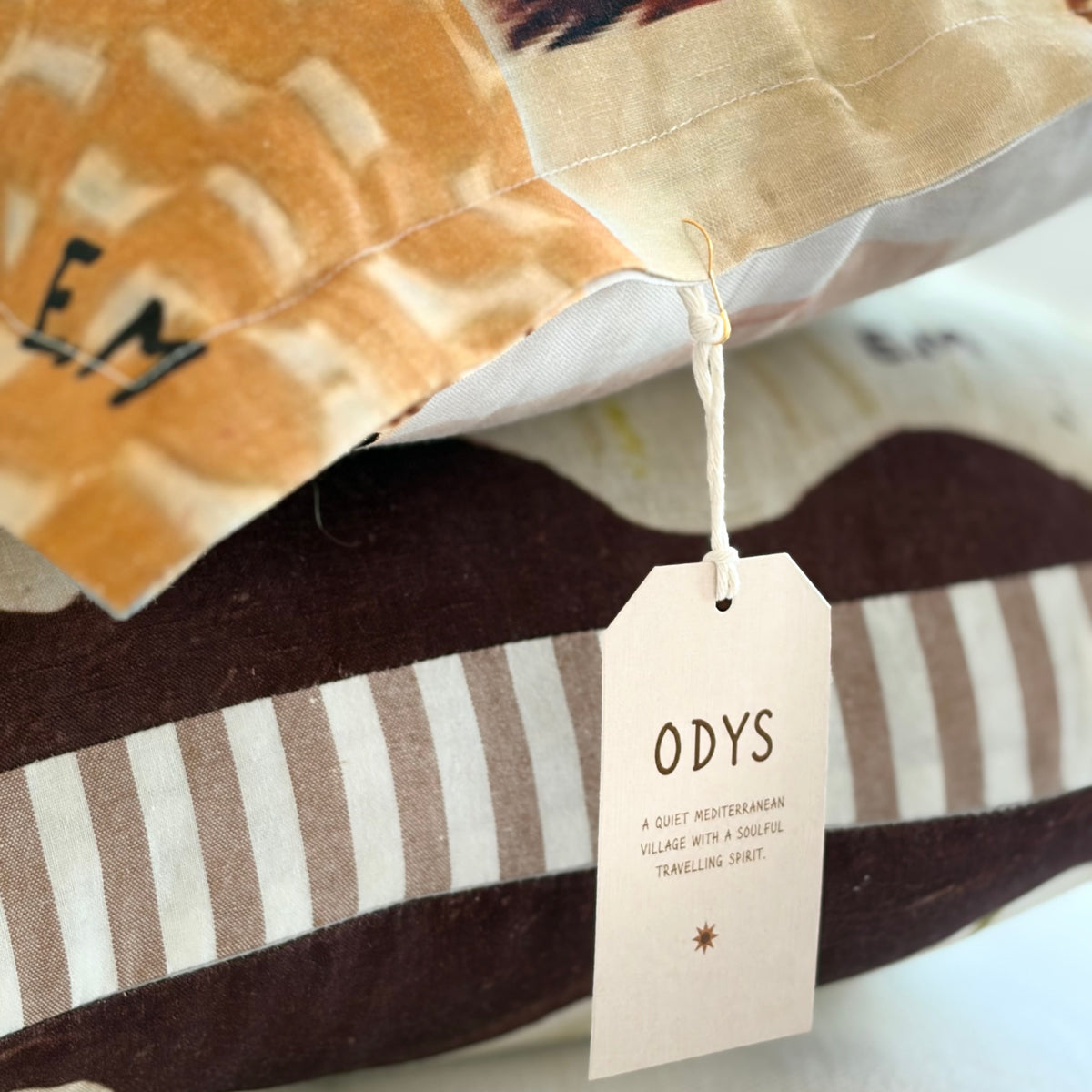 Little Nordic Sol ODYS The Wandering Soul illustrated horse cushion styled with striped cushions and natural linen bedding