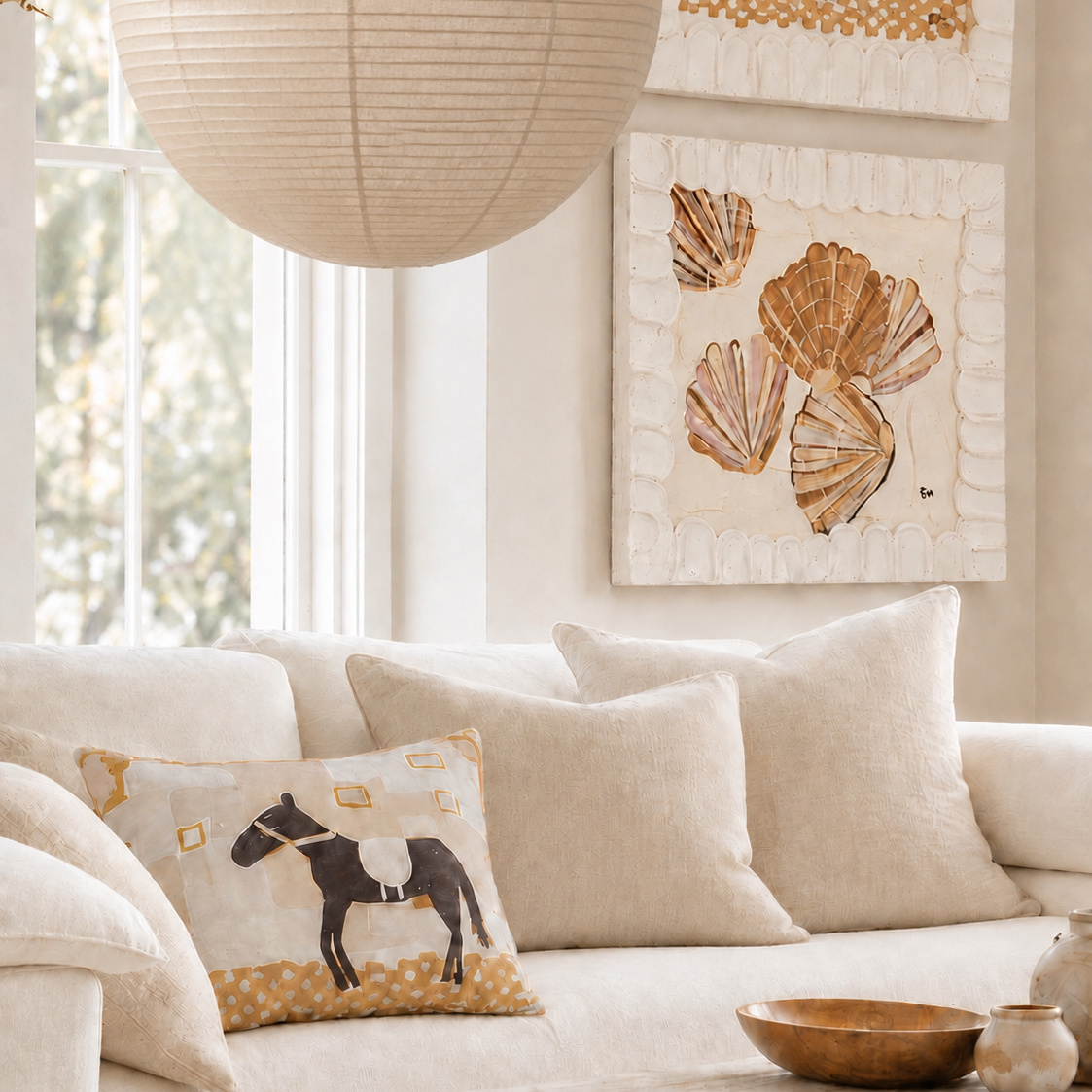Little Nordic Sol ODYS The Wandering Soul illustrated horse cushion styled on a cream sofa in a light-filled neutral living room