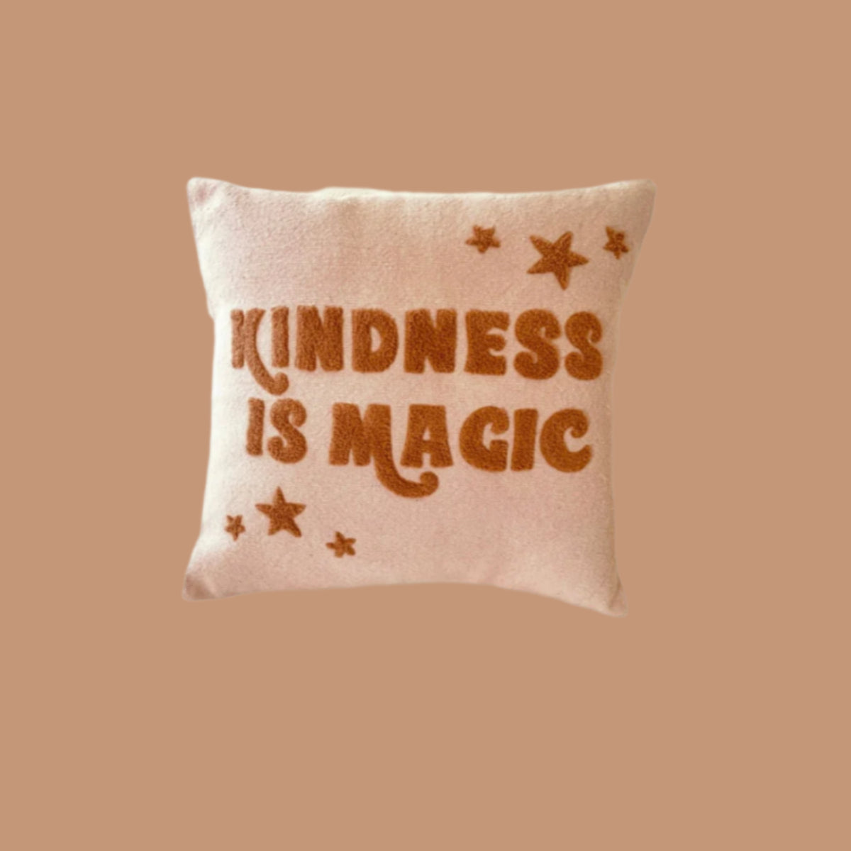 Cushion Cover with looped design saying Kindness Is Magic for children's room decor in pink and bronze writing