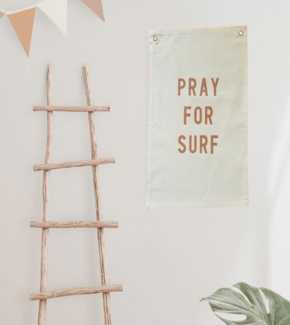 Canvas Pray for Surf Wall banner printed on natural canvas with eyelets for hanging.