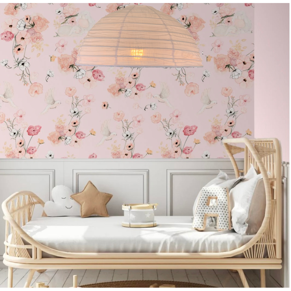 A blush pink linen light shade in a minimalist style, displayed in a room setting with a white daybed in a girl's bedroom.
