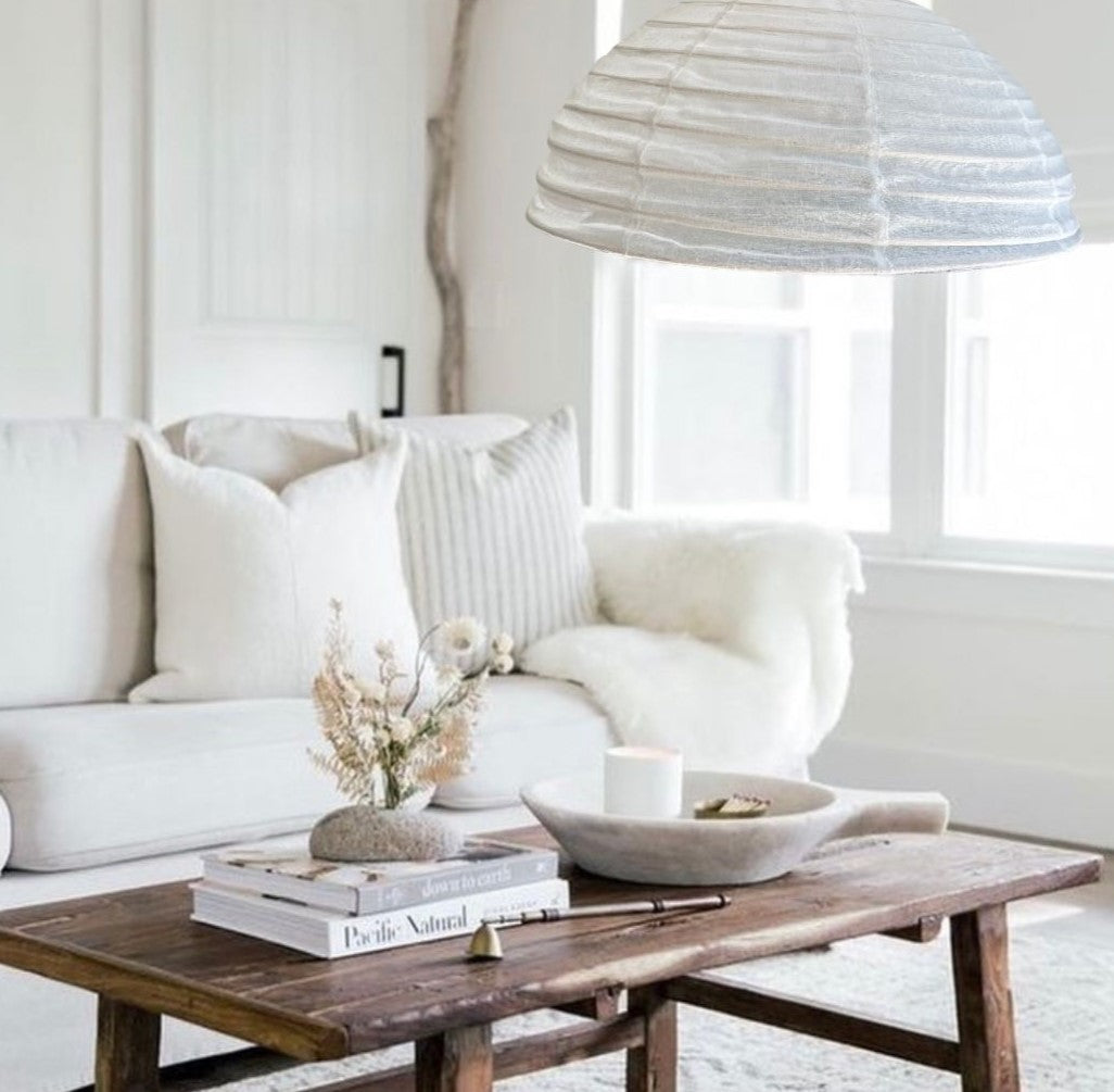 A light linen shade in a warm white colour, half dome-shaped, creates a natural decor.