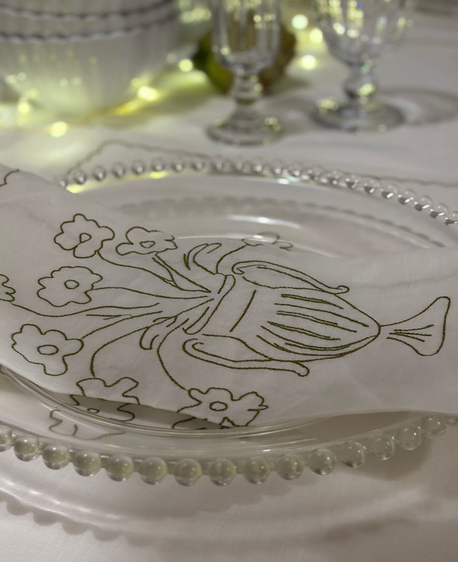 Decorative glass plate with floral design on a table setting.