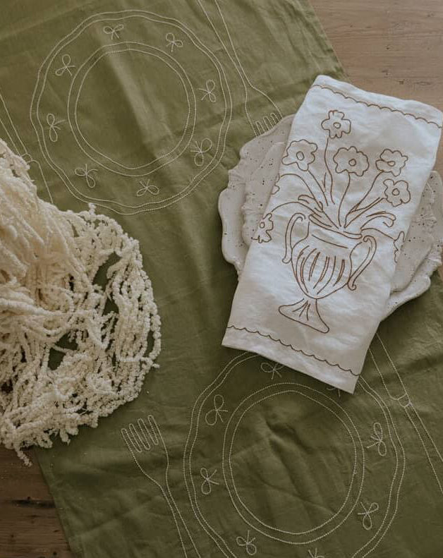 Embroidered fabric with floral design on a green background 