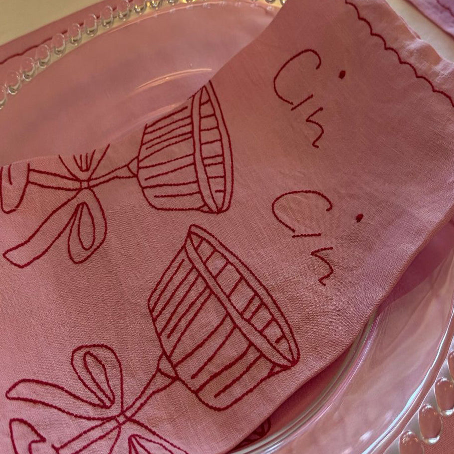Pink Placemat on glass plate with embroidery cin cin cheers 