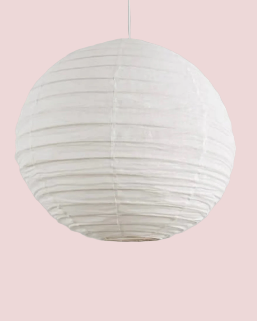 White linen lantern hanging against a plain background