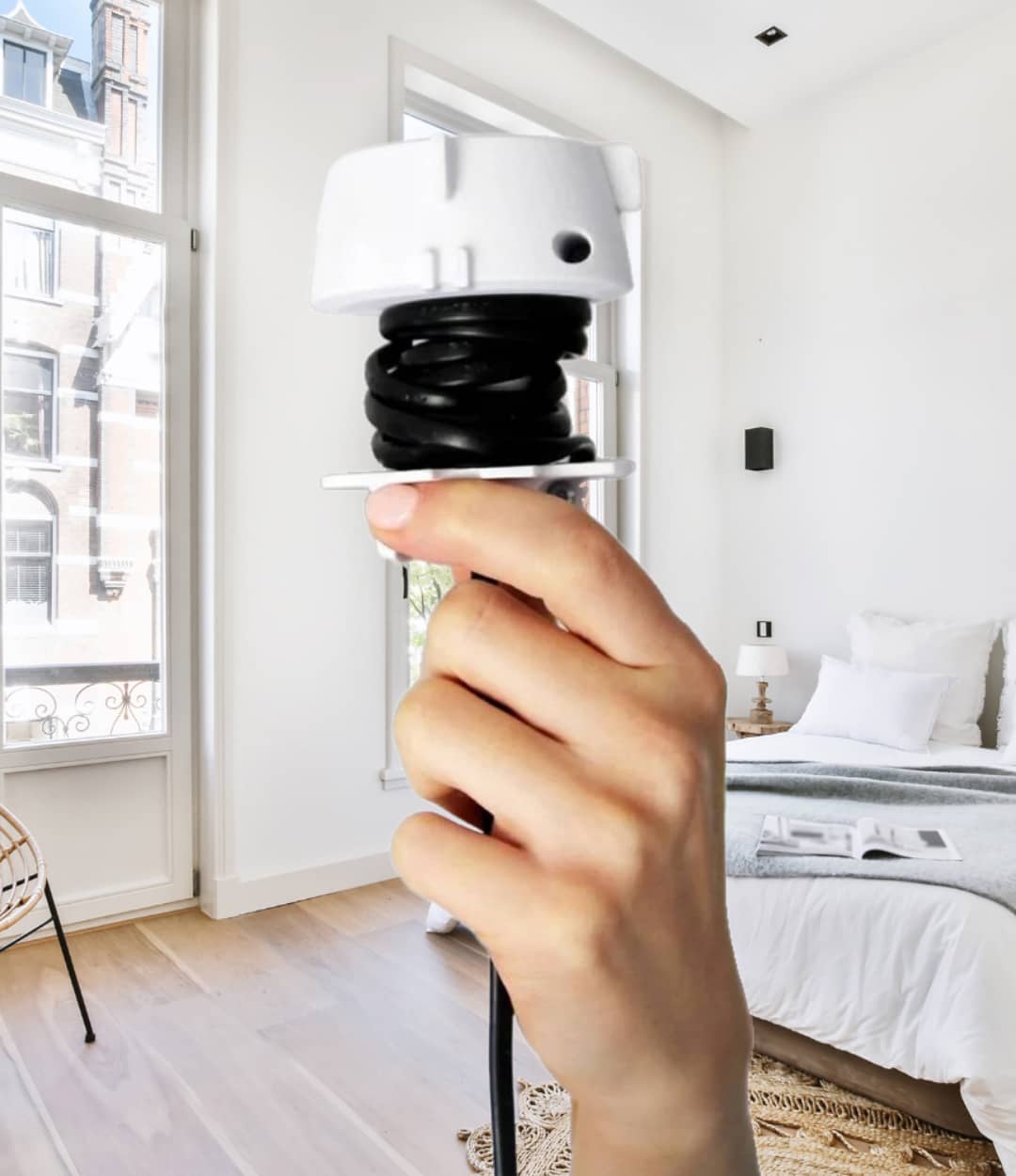 Sol pendant adapter  connecting a round linen lampshade in a room with a bed and window.
