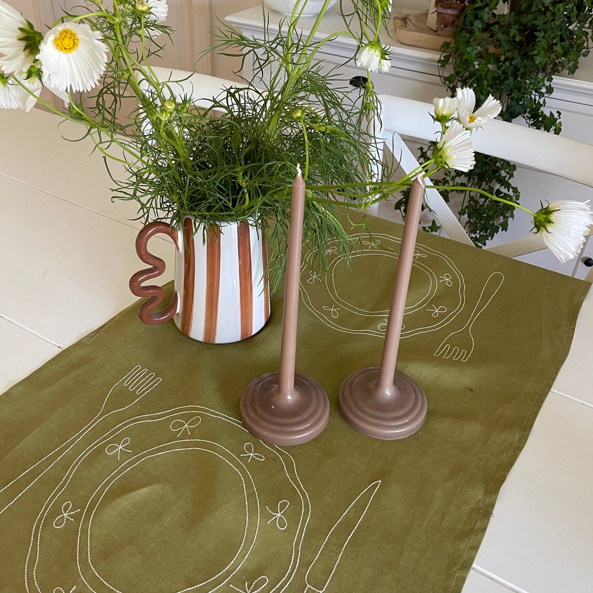 Little Nordic Sol Duo olive linen placemat styled for entertaining with flowers and taper candles