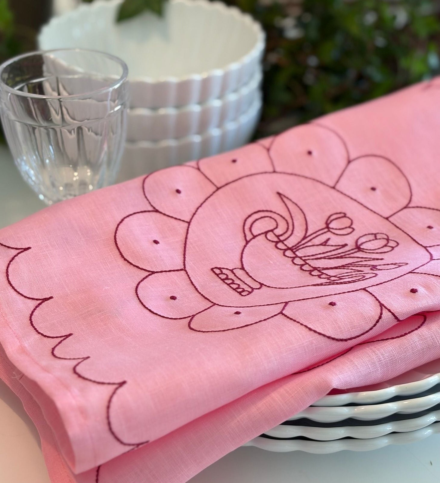 Pink fabric with embroidered design on a table setting