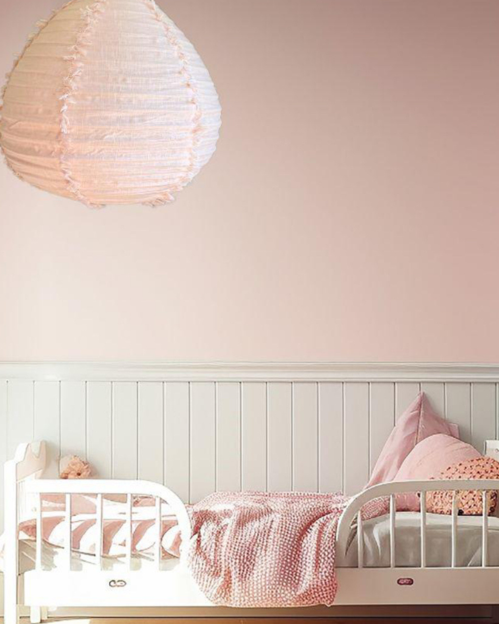 pink bedroom with pink hanging linen  fringed pendant light shade