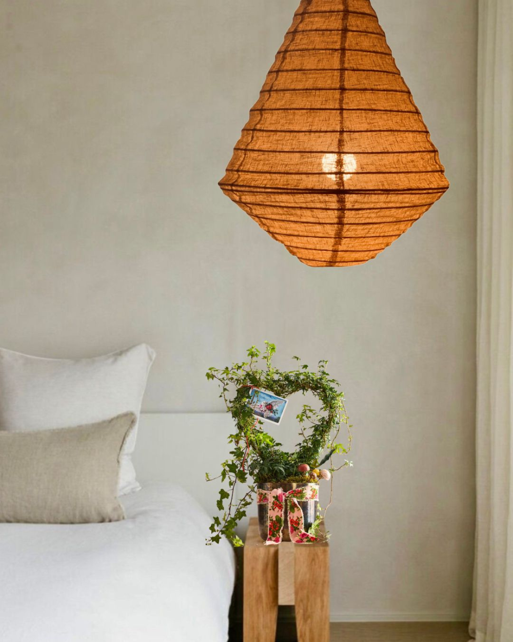 Bedroom with a hanging lamp, diamond-shaped rust organic linen.