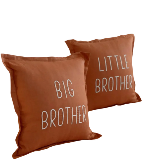 Two brown pillows with 'Big Brother' and 'Little Brother' text on a brown background