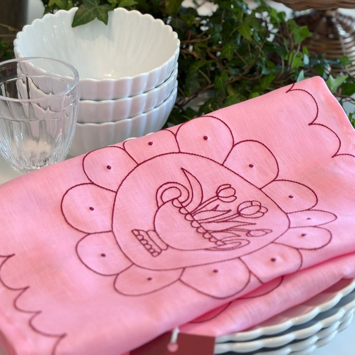 Little Nordic Sol Tulip Plate pink linen placemat with raspberry red embroidery styled with tableware.