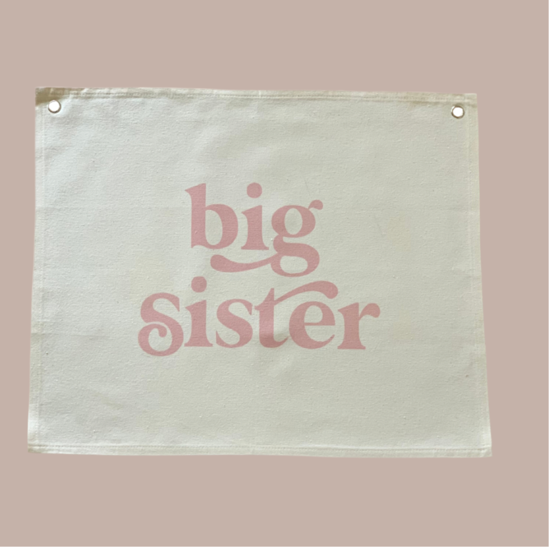 Canvas sign with 'big sister' text on a beige background