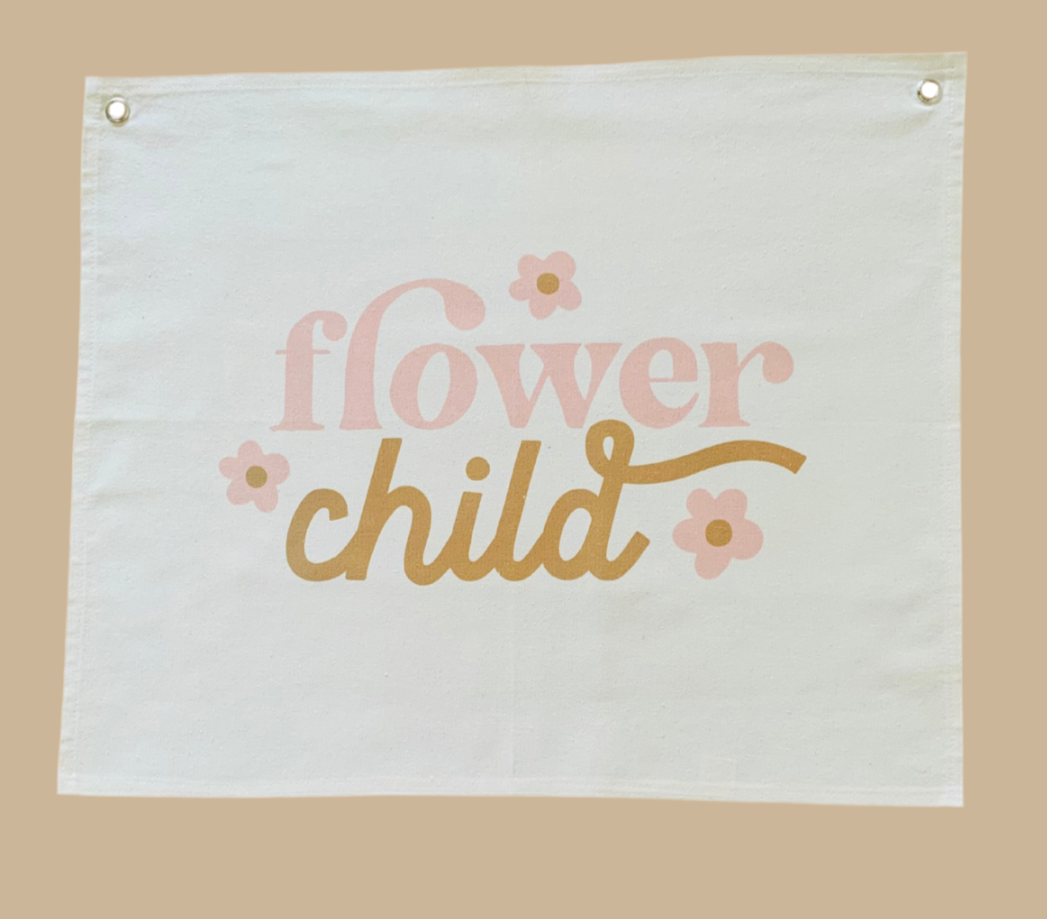 Fabric banner with 'flower child' text and floral designs on a beige background