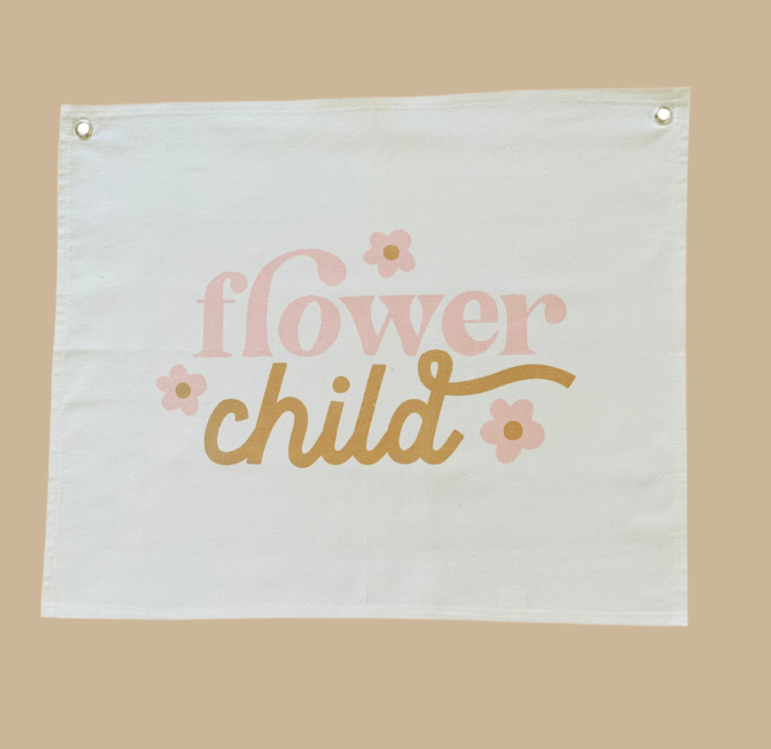 Fabric banner with 'flower child' text and floral designs on a beige background