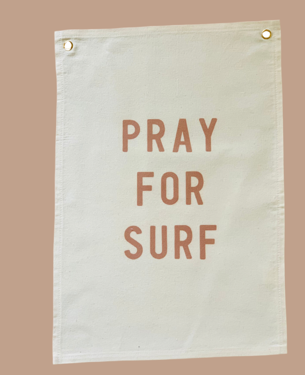 Canvas banner with 'PRAY FOR SURF' text on a beige background